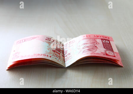 Indian currencies forming the shape of a bank book Stock Photo