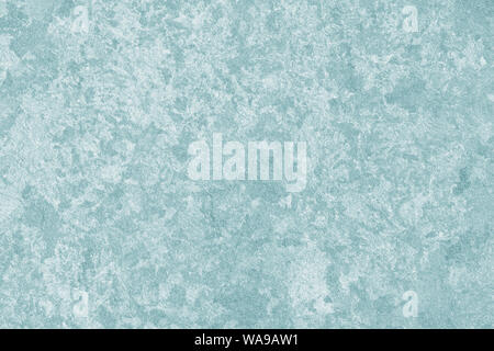 Luce verde testurizzata parete di calcestruzzo. Stucco di muro grigio. Configurazione astratta grigio con macchie di vernice sulla superficie. Foto Stock