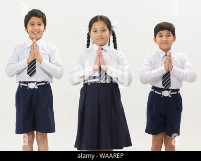 School children praying with hands joined together Stock Photo