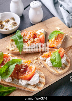 Italian panini con formaggio, pomodori e rucola. Cucina Mediterranea tradizionale. Foto Stock