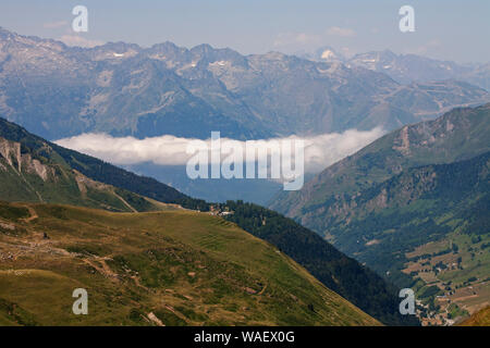 Guardando verso la città di Luz con basse nubi nella valle dalla strada per il Col du Tourmalet Parco Nazionale dei Pirenei Francia luglio 2015 Foto Stock