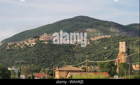 Piccolo antico borgo medievale città sulla collina Sermoneta con il Castello Caetani sulla parte superiore e Torre Normanna torre in colline ai piedi delle montagne Carbolino sul lato destro. Foto Stock