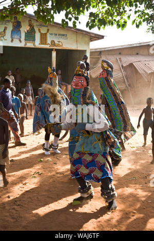 Africa occidentale Benin. Maschera Gelede ballerini eseguono come bambini watch. Foto Stock