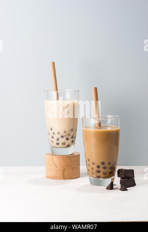 Due bicchieri di cioccolato di boba tea/ buble tea su sfondo bianco. Foto Stock