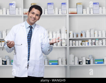 Farmacista maschile che mostra medicinali Foto Stock