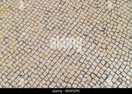 Un background in ciottoli - tipicamente trovati in molte città europee come Lisbona. Foto Stock