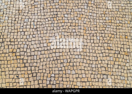 Un background in ciottoli - tipicamente trovati in molte città europee come Lisbona. Foto Stock