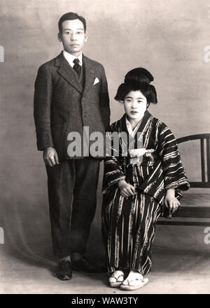 [ 1920s Giappone - giovane giapponese giovane ] - giovane giapponese giovane. Il 33 anno vecchio indossa una tuta occidentale e i suoi 24 anni, moglie di un tradizionale kimono. La foto è datata gennaio 1926 Showa (2). Xx secolo gelatina vintage silver stampa. Foto Stock