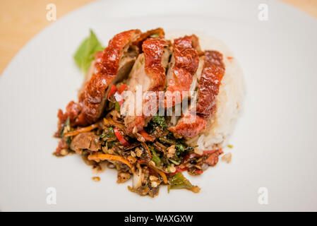 Stir-fritte anatra arrosto e basilico e uovo fritto con riso, cibo tailandese Foto Stock