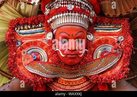 Danzatrice presso una tradizionale cerimonia Theyyam in un tempio di Kannur, India. Theyyam Kerala è più popolare rituale forma d'arte. Foto Stock