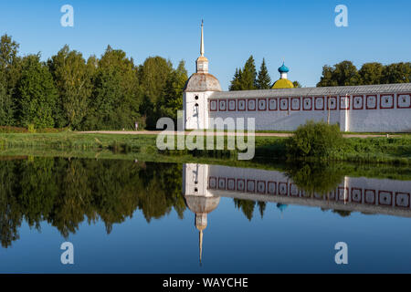 Southwest Сorner tower e la parete di Tikhvin Assunzione (ipotesi) monastero con riflesso nello stagno. Tikhvin, Russia Foto Stock