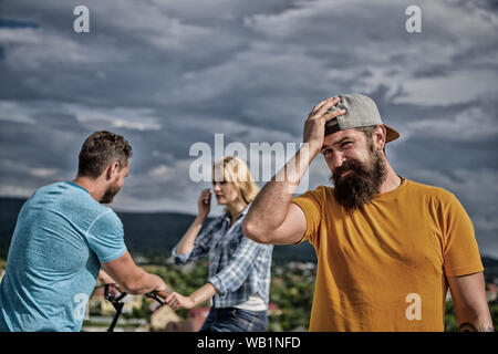 Nessun romantico nella sua vita. Tanga uomo sente lonely giovane dating dietro di lui. L'uomo rammarico non ha chiesto il suo andare fuori. Ora lei incontri con un altro ragazzo. Hipster spiacevoli nella faccia anteriore del giovane nell'amore. Foto Stock