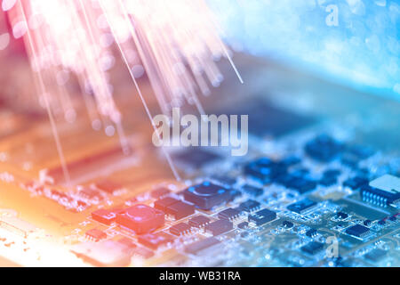 Primo piano sulla scheda elettronica e neon luci elettriche, offuscata e tonalità dello sfondo elettronico in rosa, blu e viola Foto Stock