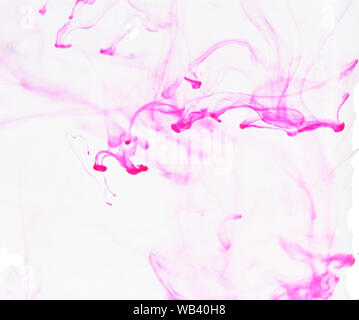 Colore rosa spalmatura di inchiostro nell'acqua , colorato fumo blur su sfondo bianco Foto Stock