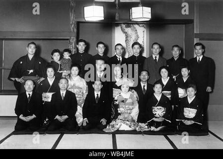 [ 1930 Giappone - Ritratto di gruppo al matrimonio giapponese ] - Famiglia foto di gruppo in occasione di una cerimonia nuziale. La maggior parte degli uomini di usura in stile occidentale tute, mentre tutte le donne indossare il kimono. Dal 1920s, matrimonio giapponese dogana ha subito una grande trasformazione a causa di influenze occidentali. Questo è chiaramente visibile in questa foto. Xx secolo gelatina vintage silver stampa. Foto Stock