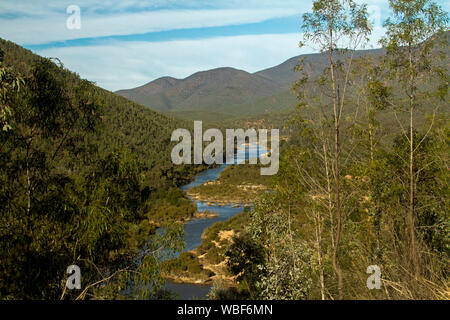 Vista delle gamme di foreste alpine del Parco Nazionale con il blu delle acque del fiume nevoso nella profonda valle di gran lunga al di sotto in Victoria Australia Foto Stock