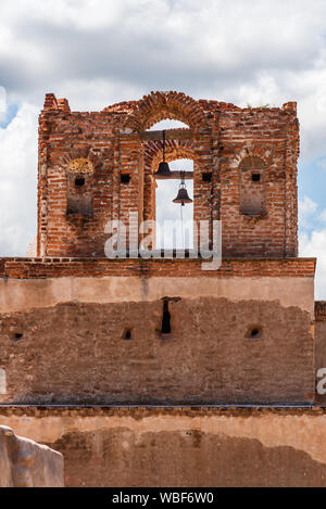 Il campanile della chiesa alla Missione di San José de Tumacácori con un cielo nuvoloso in background. Foto Stock