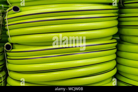 Tubo flessibile da giardino in un rotolo per irrigazione. Attrezzi da giardino. Foto Stock