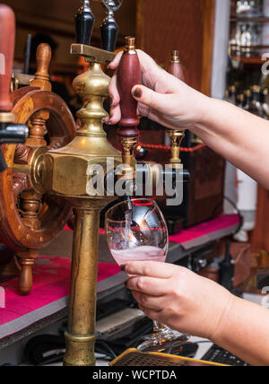 Barista serve la canna da bere. La mano e il vino tocca. Foto Stock