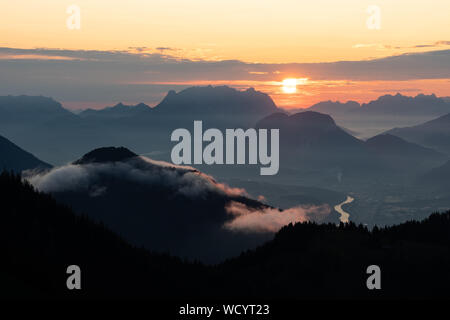 Sunrise over the tyrol alm high over the mountains scenery with clouds and river Foto Stock