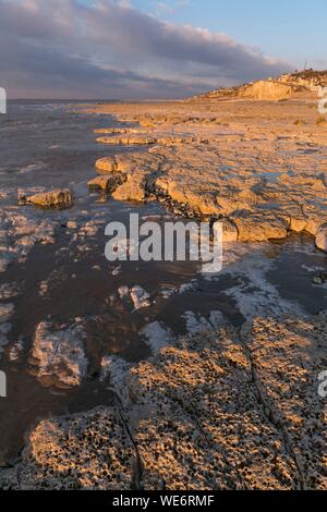 Francia, Somme, Ault, il villaggio sulla sua rupe nella luce del tramonto la bassa marea scopre l'altopiano gessoso mangiata dal mare e le pietre focaie che sono a filo Foto Stock