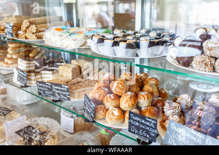 GRODNO, Bielorussia - Agosto 2019: caffetteria windows con torte, dolci, gelati, pasties, waffle, ciambelle, torte e altri dolci in una caffetteria alla moda Foto Stock