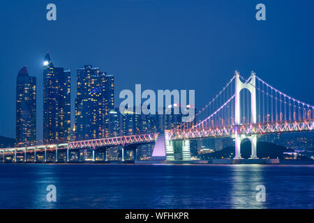 Gwangan Bridge e grattacieli di notte. Busan, Corea del Sud Foto Stock