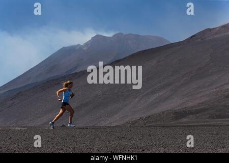 L'Italia, Sicilia Etna Parco Naturale Regionale del Monte Etna, Sito Patrimonio Mondiale dell'UNESCO, versante Nord, eruzione del luglio 27, 2019, donna pratica della corsa Foto Stock