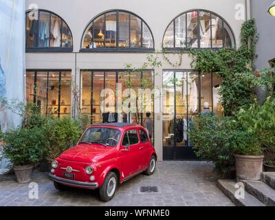 Francia, Parigi, Fiat 500 parcheggiate in merci del negozio di decorazione su cortile Boulevard Beaumarchais Foto Stock