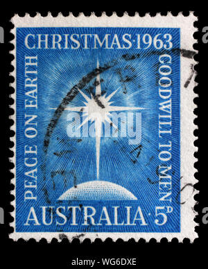 Natale timbro stampato in Australia mostra la brillante stella, Globe, iscrizione "Pace sulla terra", "Buona volontà agli uomini, circa 1963. Foto Stock