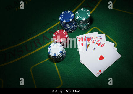 Carte e chips per il poker sul tavolo verde, vista dall'alto. Foto Stock