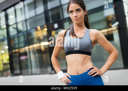Foto di giovani attraenti felice donna fitness all'aperto Foto Stock