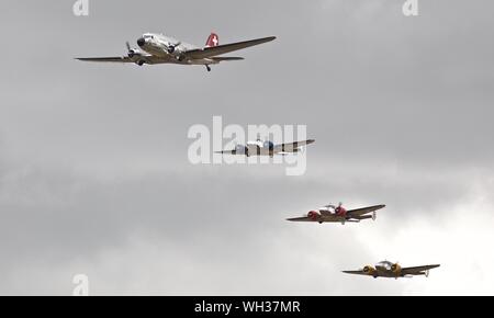 La Swissair Douglas DC-3 'N431HM' volare in formazione con 3 Beechcraft Model 18's al Flying Legends su Airshow xiv Luglio 2019 Foto Stock