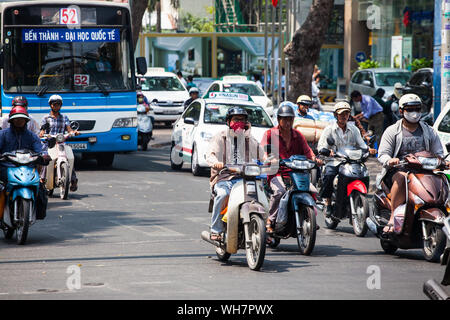 Modalità popolare di trasporto, un uomo che parla al telefono durante la guida. La città di Ho Chi Minh, Vietnam Foto Stock