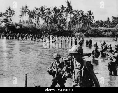 Le truppe degli Stati Uniti sulla isola di Leyte. Utilizzando una fune come una guida da costa a costa, i soldati degli Stati Uniti 7 Divisione file attraverso il fondale del fiume Marahang, isola di Leyte nel loro avanzamento verso le posizioni giapponesi nelle colline vicino a Santa Ana. Nonostante infido fiumi, l'Americano e Phillipino le forze sono state facendo un lento ma costante progresso contro il nemico armato di unità nella zona. Foto Stock