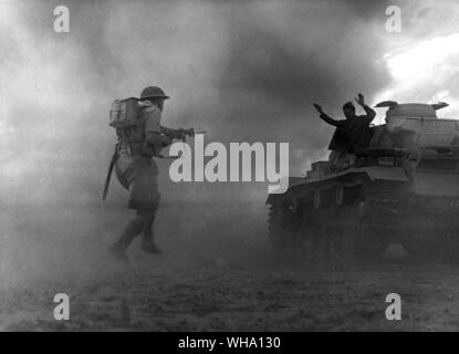 WW2: un elemento di un messo k.o. tedesco serbatoio si arrende come fanteria britannico rush il suo serbatoio a Alamein. 1942. Foto Stock