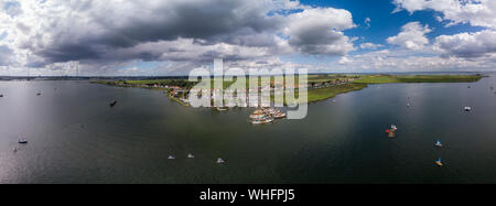 Panorama dell'antenna del piccolo villaggio Durgerdam nei pressi di Amsterdam con il suo porto da diporto area con molte barche a vela ormeggiata contro un cielo blu Foto Stock