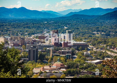 Bassa vista aerea del centro cittadino di Ashevill, Carolina del Nord e le montagne Foto Stock