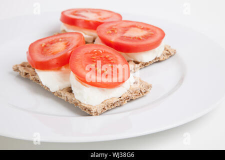 Fette biscottate con fette di pomodoro e formaggio Foto Stock