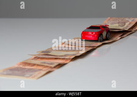 Indian paper currency with representing toy car Stock Photo