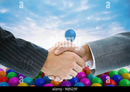 Immagine composita di handshake business contro terra futuristica galleggianti in aria Foto Stock