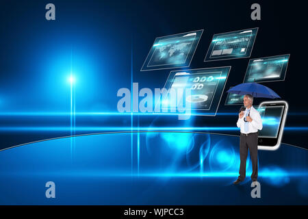 Happy businessman holding ombrello contro business interface Foto Stock