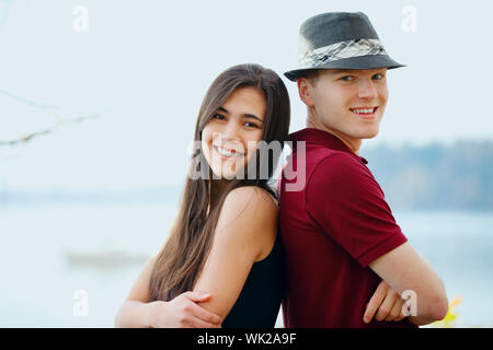 Giovane e bella interracial giovane in piedi di schiena, il lago in background Foto Stock
