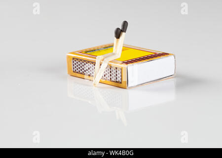 Two matchsticks represent love or friendship on a matchbox Stock Photo