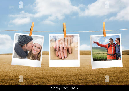 Immagine composita della foto istantanea appeso su una linea contro campo e cielo blu Foto Stock