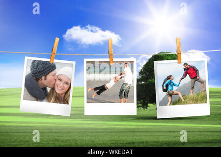 Immagine composita della foto istantanea appeso su una linea contro campo e cielo blu Foto Stock