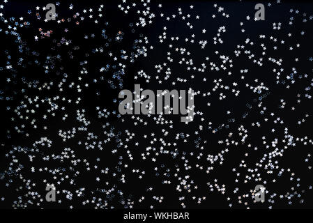A forma di stella paillettes argento sfondo. Foto Stock