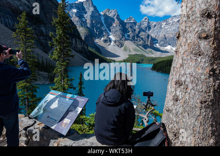 Banff, Lug 25: Donna di scattare una foto di Moraine Lake, il Parco Nazionale di Banff il Lug 25, 2019 a Banff, Canada Foto Stock