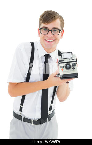 Geeky hipster tenendo una fotocamera retrò su sfondo bianco Foto Stock