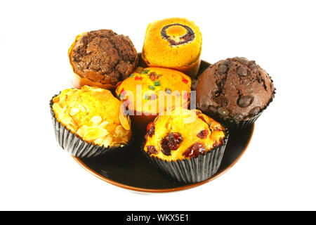 Tortini assortiti e muffin appena sfornato sulla superficie bianca Foto Stock